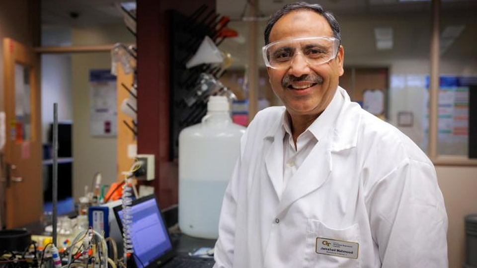 Researcher in lab with laptop